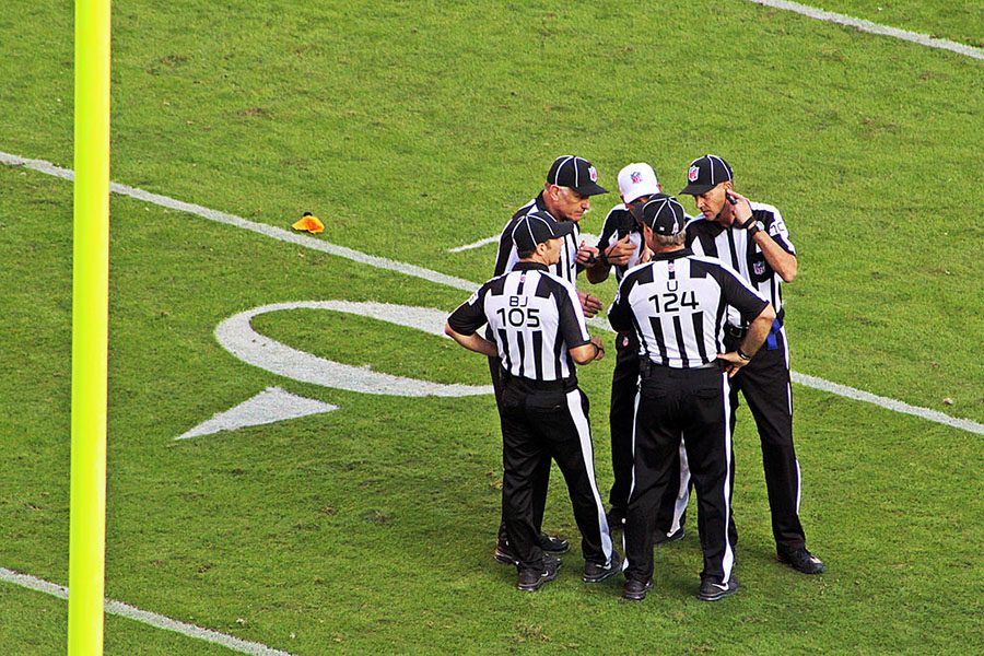 NFL Officials convening over a flag called. NFL officials are on the ropes early in the 2018 season after a controversy based on calls.