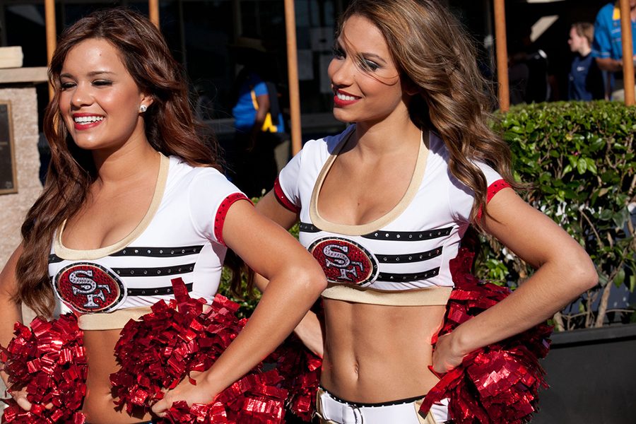The two 49ers cheerleaders smile after a win at their San Fransisco stadium.