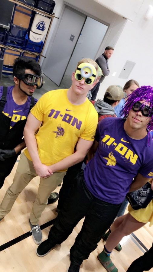 Abdul and Jacob dress up with their friend Luke as minions at the volleyball game.