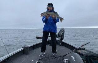 Sunder OHara holding a walleye during a rainy day last year