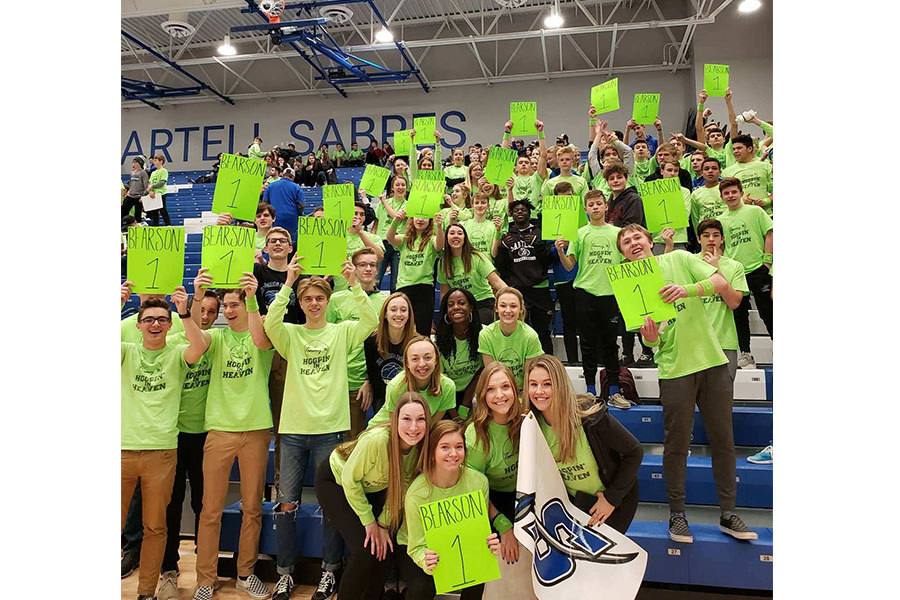 Sartell High School basketball fans show off signs in support of the foundation
