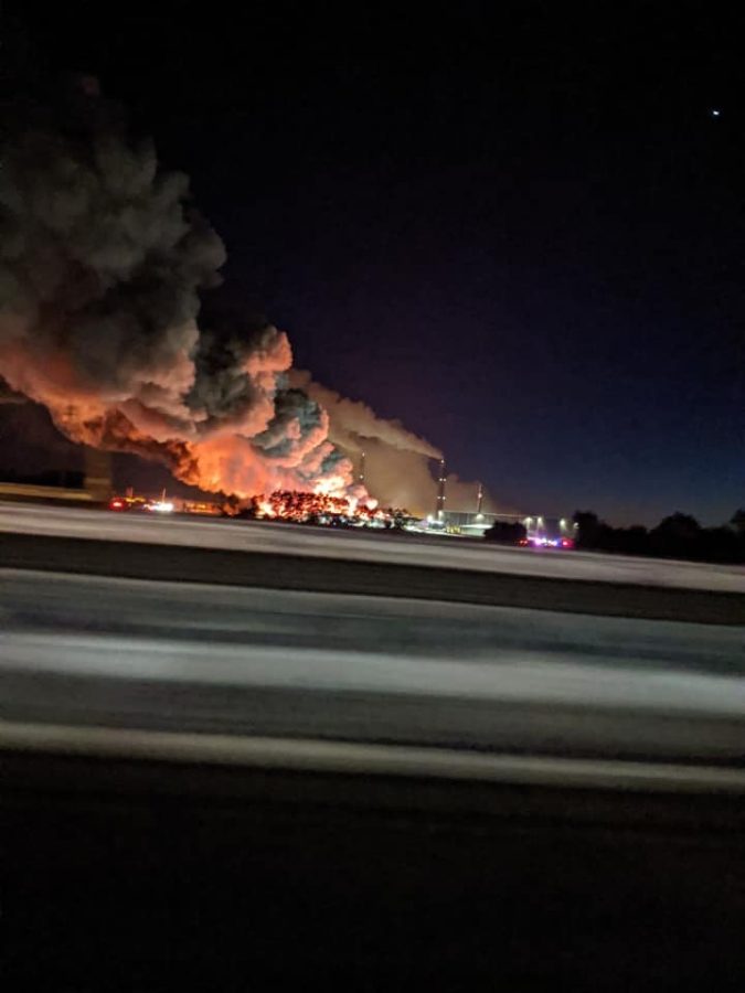 The fire is seen from a nearby road.