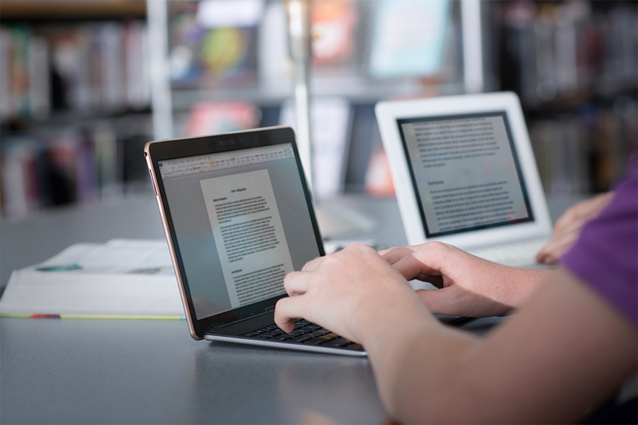 Students work at home distance learning while writing essays