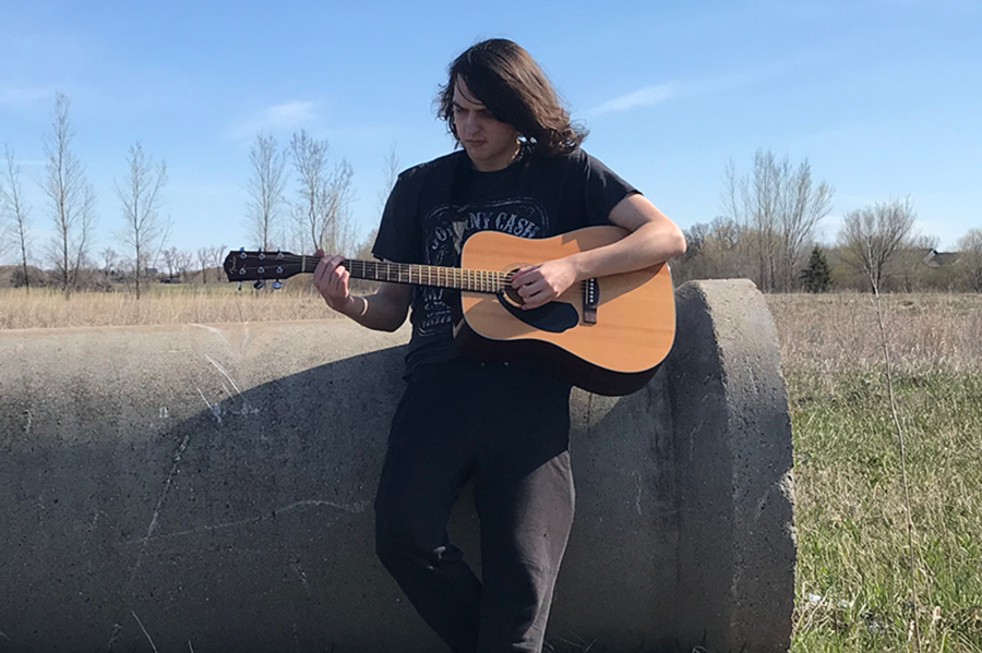 I am playing guitar in a field near the Coborns on Pinecone. 