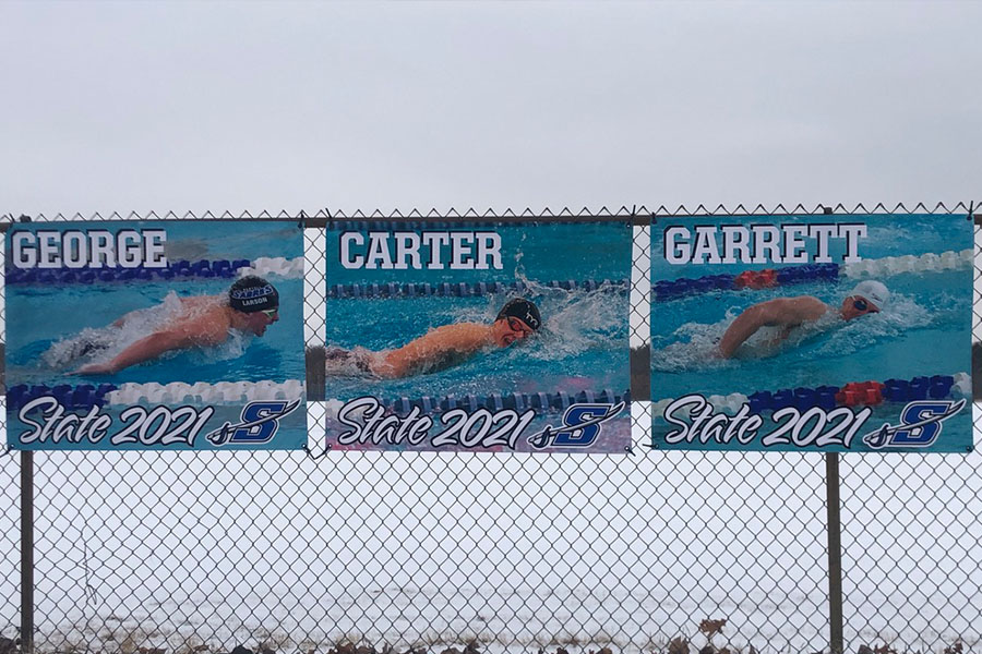 The Larson brothers are enjoying swimming together on the swim team. 