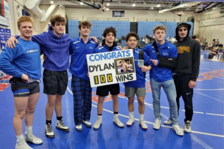 Dylan Enriquez and seniors celebrating after his 100th win at Cambridge High School.
