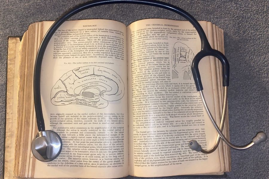 The 27th addition of the Grays Anatomy textbook with medical stethoscope around. 
