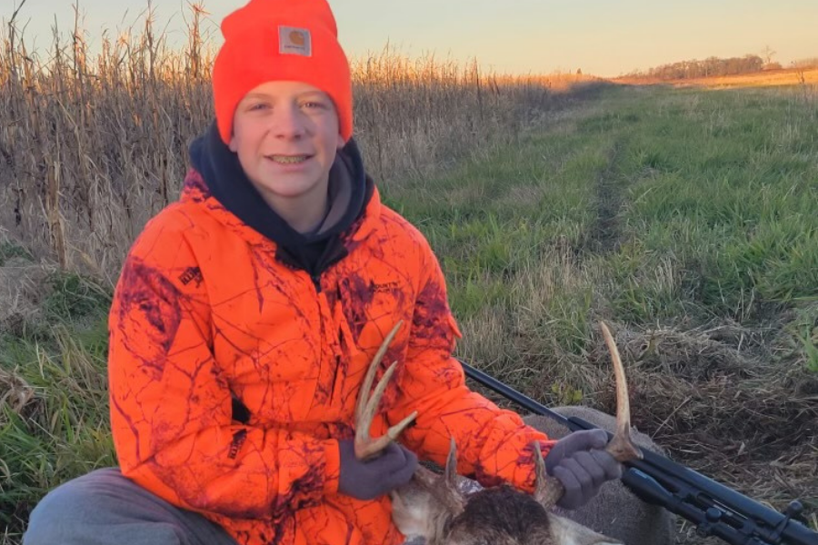 Ethan poses for a photo after shooting a buck.