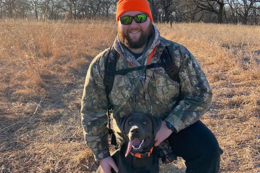 Mr. Sailor posing with his hunting dog.