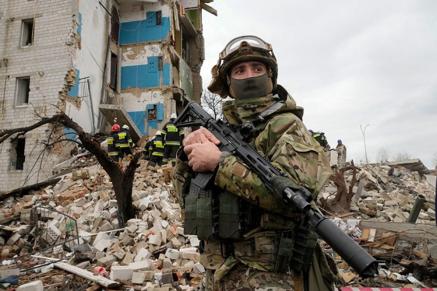 Ukrainian soldier posted outside home that was bombed by Russian troops