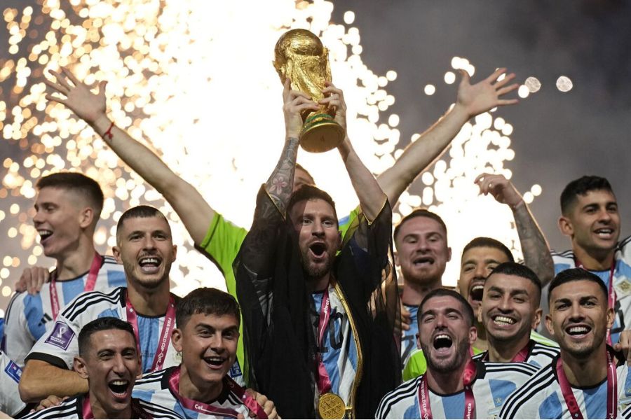 Messi and his teammates celebrating after winning the 2022 FIFA World Cup.