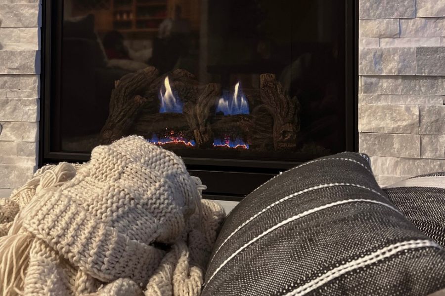 Cozy up by the warm fireplace with a nice blanket.