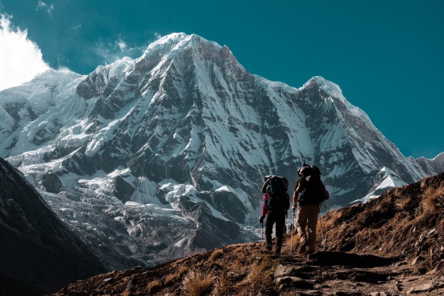 Two hikers trekking up to Mount Annapurna in the year 2017.