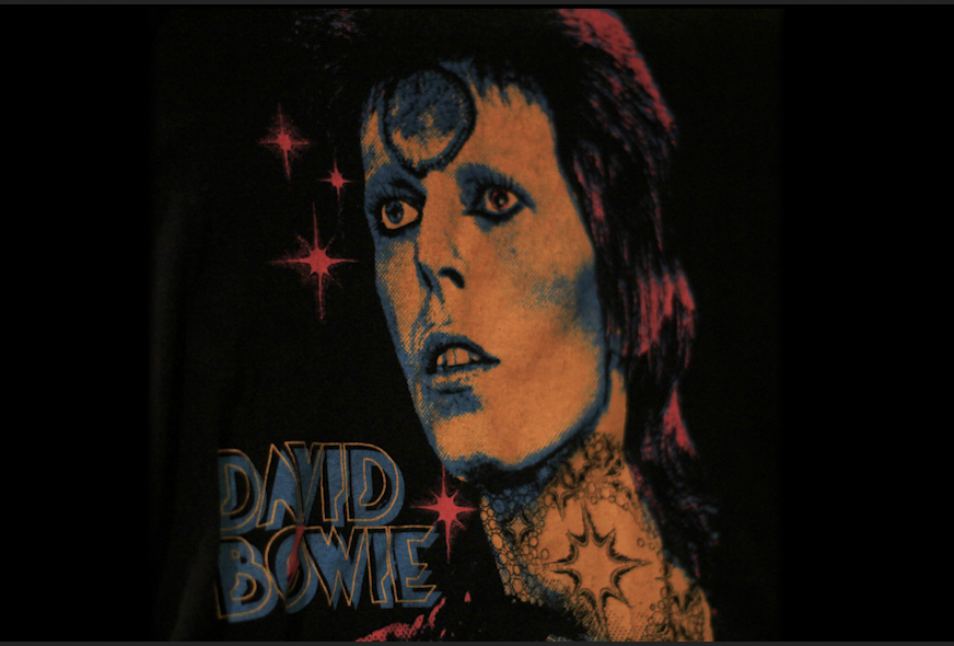 One+of+my+favorite+shirts+I+own+is+merchandise+of+David+Bowie%2C+specifically+him+dressed+as+the+titular+Ziggy+Stardust%2C+immortalized+in+the+bright+psychedelic+color+scheme+and+overall+design.+