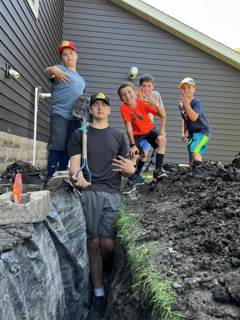 The neighbor hood kids helping Tanner and his brother with some yard work. 