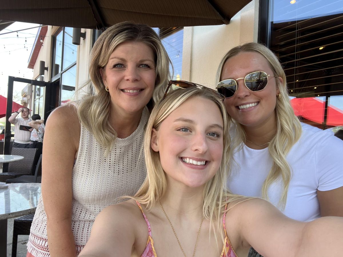 Kylee, her mom, and her sister spending quality time together outside. 