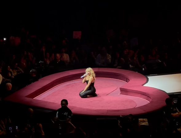 Sabrina Carpenter speaking to the crowd at the Short n' sweet tour. 
