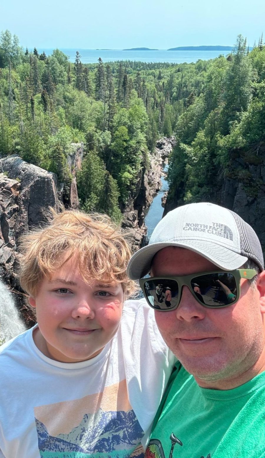 Dane poses with his Dad, Josh, for a photo with a beautiful view! (Photo used with permission from Dane Nelson)