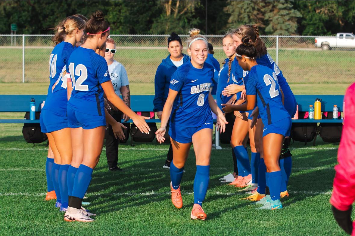 Kalyn running through the team for the starting line-up during the first season game at home. 