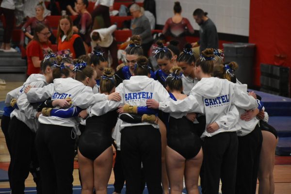 During the Elk River meet, the Sartell Gymnastics team huddled up for a pep talk. (Photo used with permission from Denise Gill)