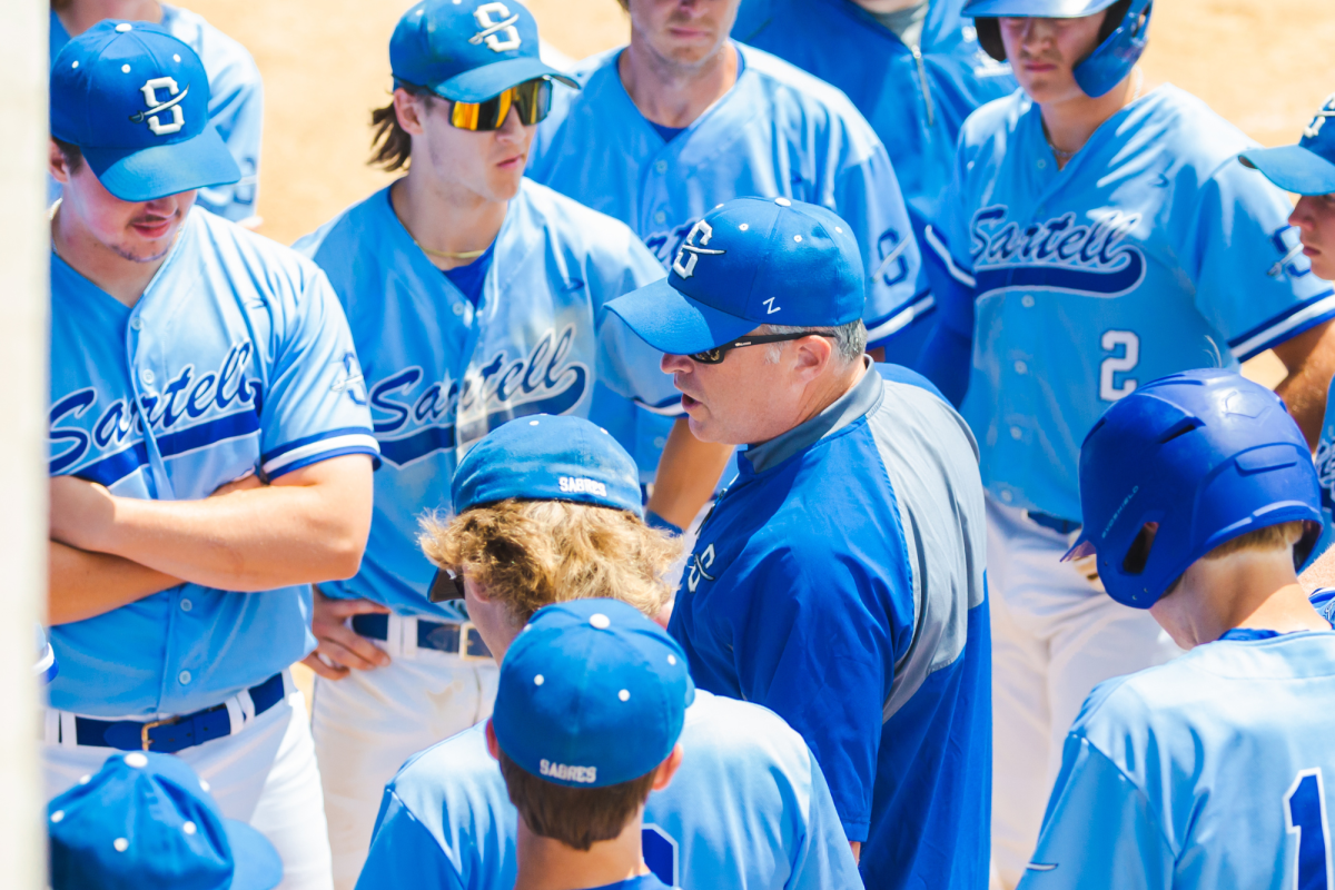 Coach Nemanich talking to players Jake Gruebele, Tyler Hemmesch, Will Brinkerhoff and the rest of the team (Photo used with permission from Angie Heckman)