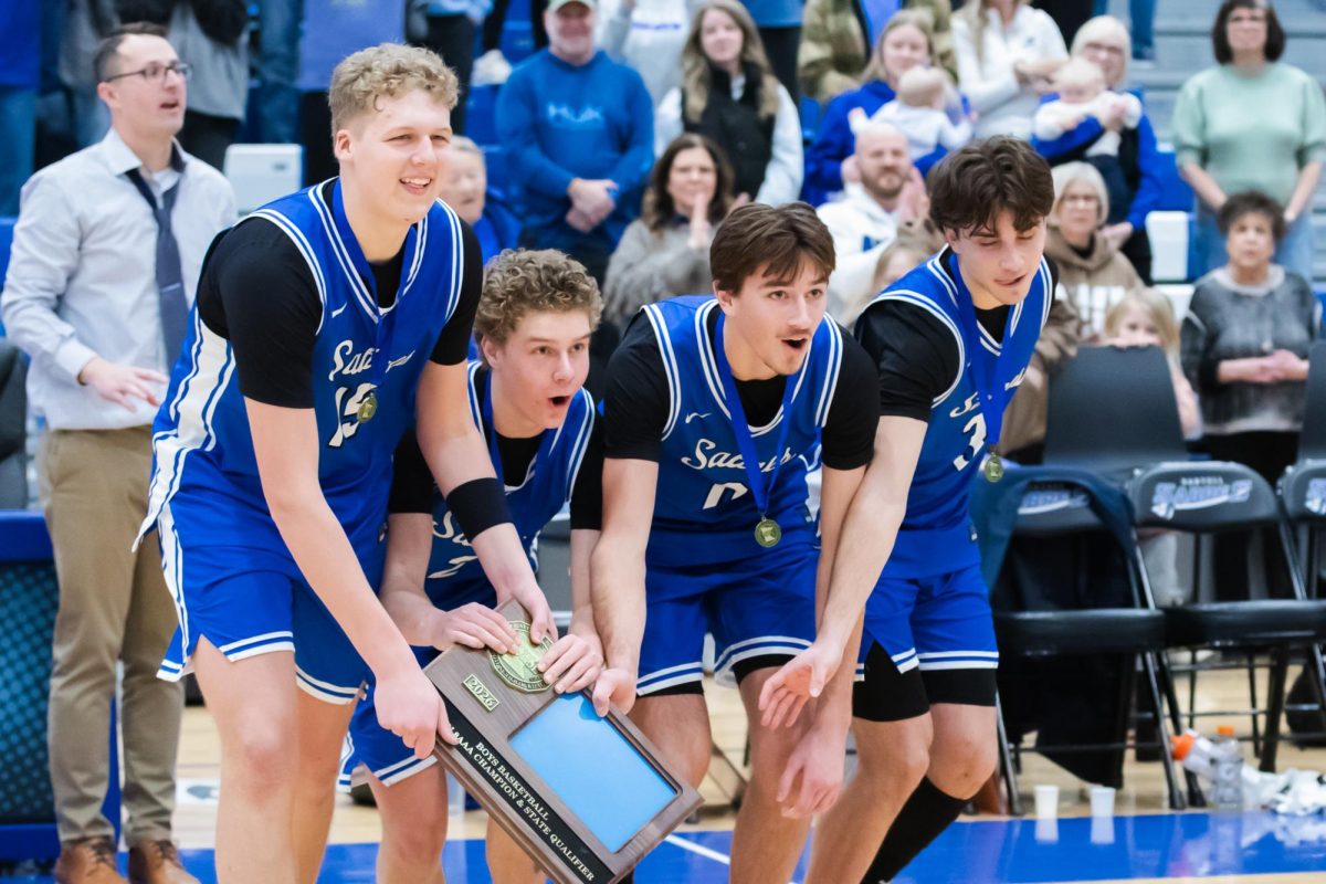 Sartell Sabres captains of the basketball team celebrated with trophy. (Photo used with permission from Angie Heckman)