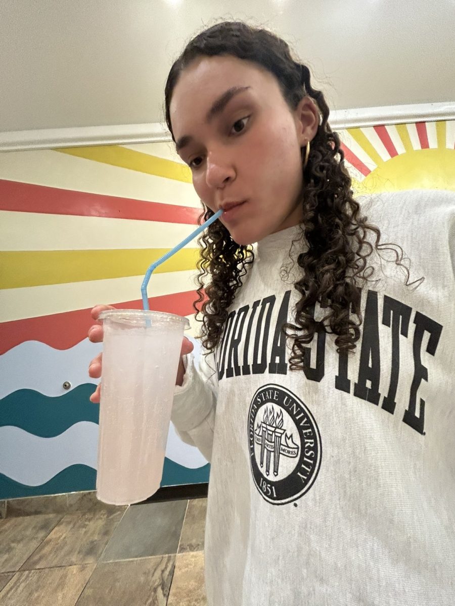 liv sipped through the straw to try her drink 